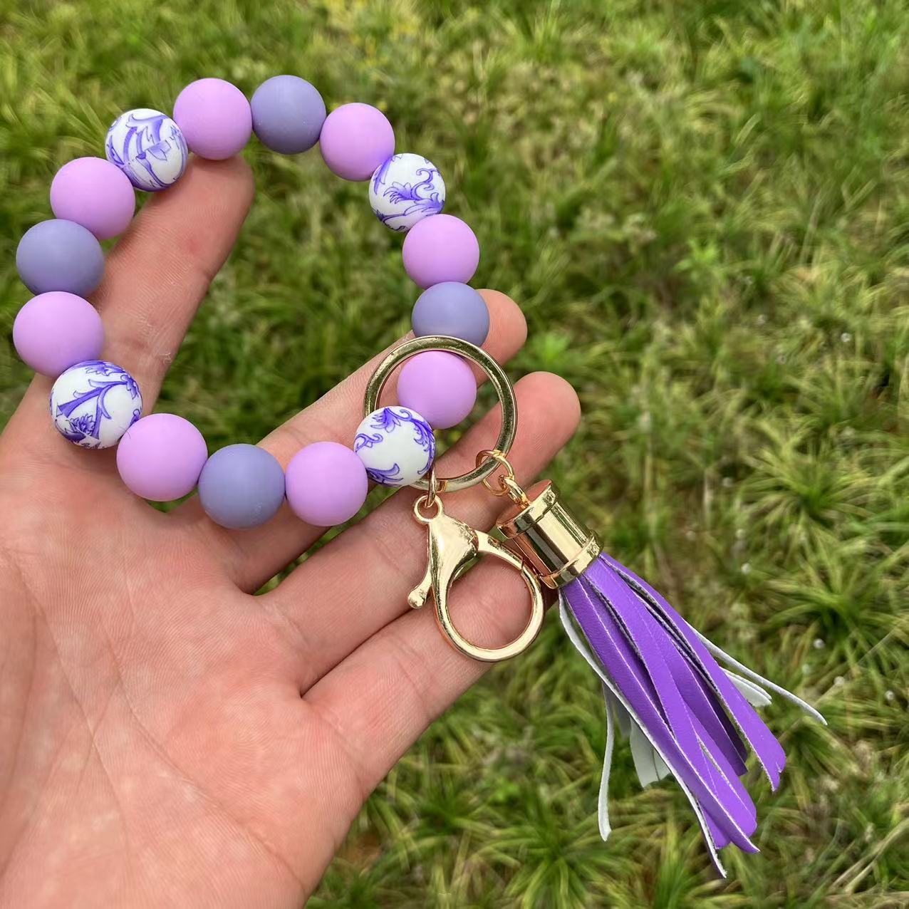 Comercio al por mayor leopardo girasol borla de silicona con cuentas llavero de muñeca